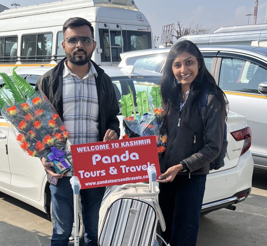 A beautiful couple receiving a warm welcome by PAnda Tours and Travels on their offberat kashmir tour package