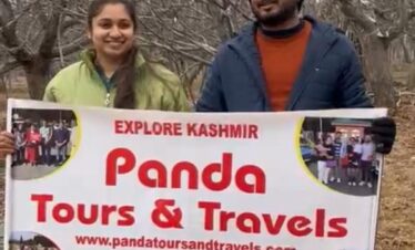A beautiful couple who booked Kashmir honeymoon package with Panda Tours and Travels getting clicked with placard