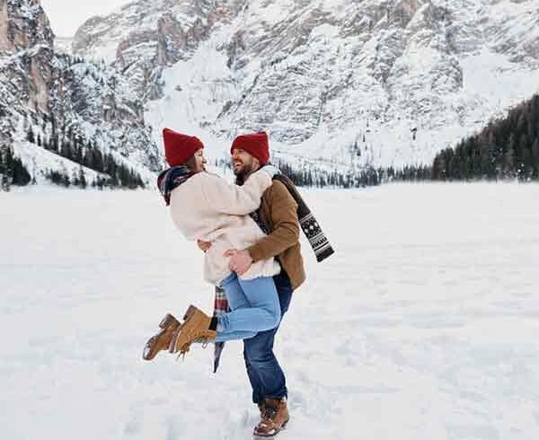 Couple enjoying an offbeat Kashmir tour package for couples in snow. | Panda Tours and Travels