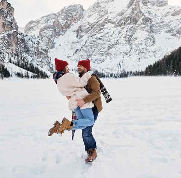 Couple enjoying an offbeat Kashmir tour package for couples in snow. | Panda Tours and Travels
