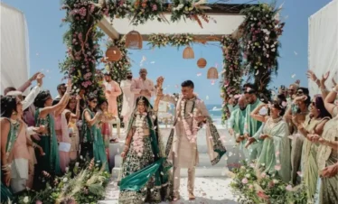 Guests showering flowers over the couple during a joyful destination wedding in Kashmir | Panda Tours and Travels