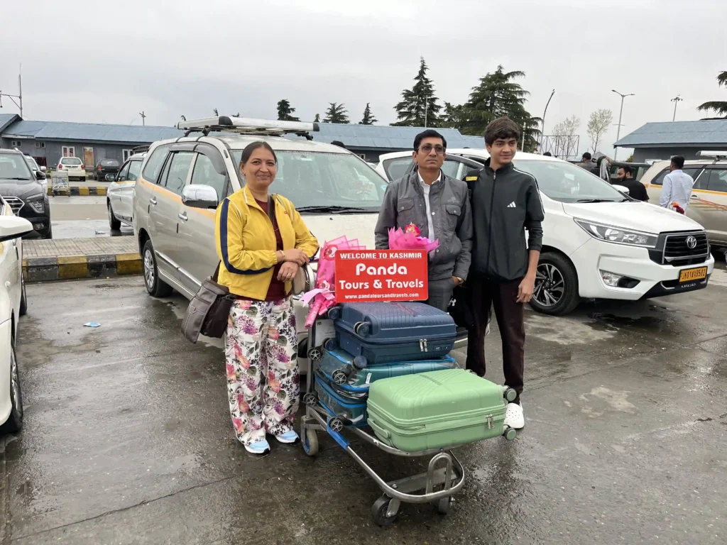 father_and-son-welcomed-with-flowers-with-panda-tours-and-travels-at-srinagar-airport