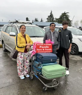 father_and-son-welcomed-with-flowers-with-panda-tours-and-travels-at-srinagar-airport