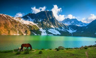 Green alpine landscape with lake and mountains on the Kashmir Great Lakes Trek