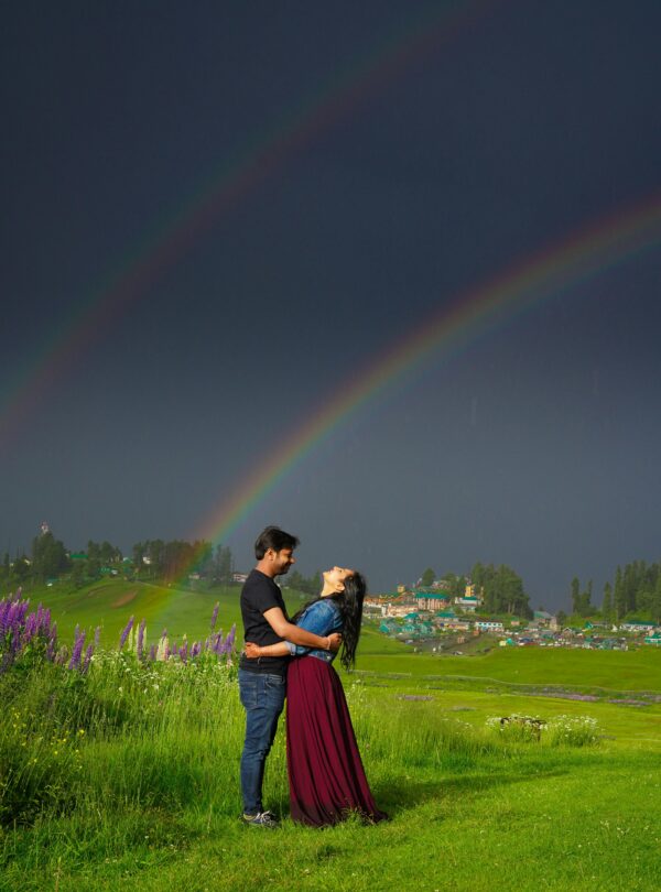 Photoshoot in Kashmir featuring a couple against a scenic mountain landscape | Panda Tours and Travels