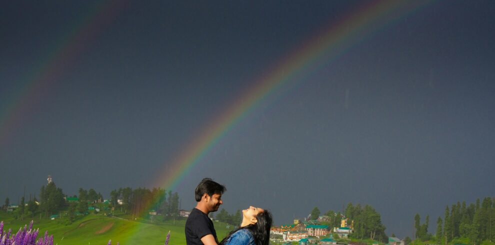 Photoshoot in Kashmir featuring a couple against a scenic mountain landscape | Panda Tours and Travels