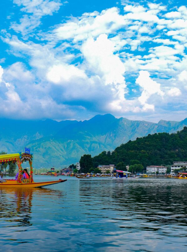 Shikara riding in Dal Lake with scenic views of Srinagar and surrounding mountains