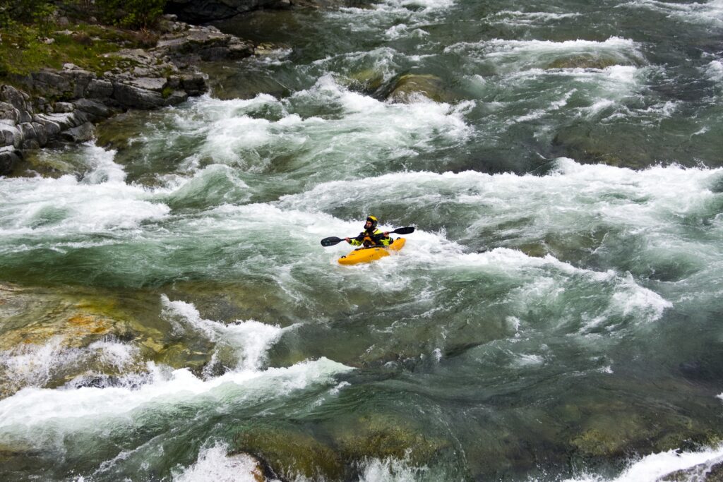 River rafting as one of the popular adventure activities in Kashmir surrounded by scenic mountains