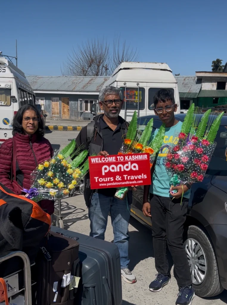 Tourists welcomed with flowers at srinagar international airport by panda tours and travels srinagar kashmir