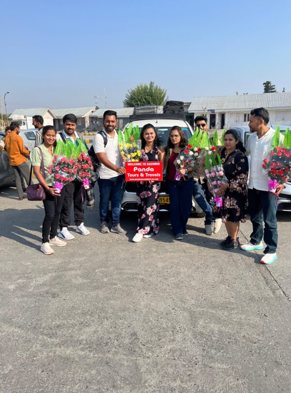 tourists welcomes at srinagar airport by panda tours and travels at arrival point with flowers