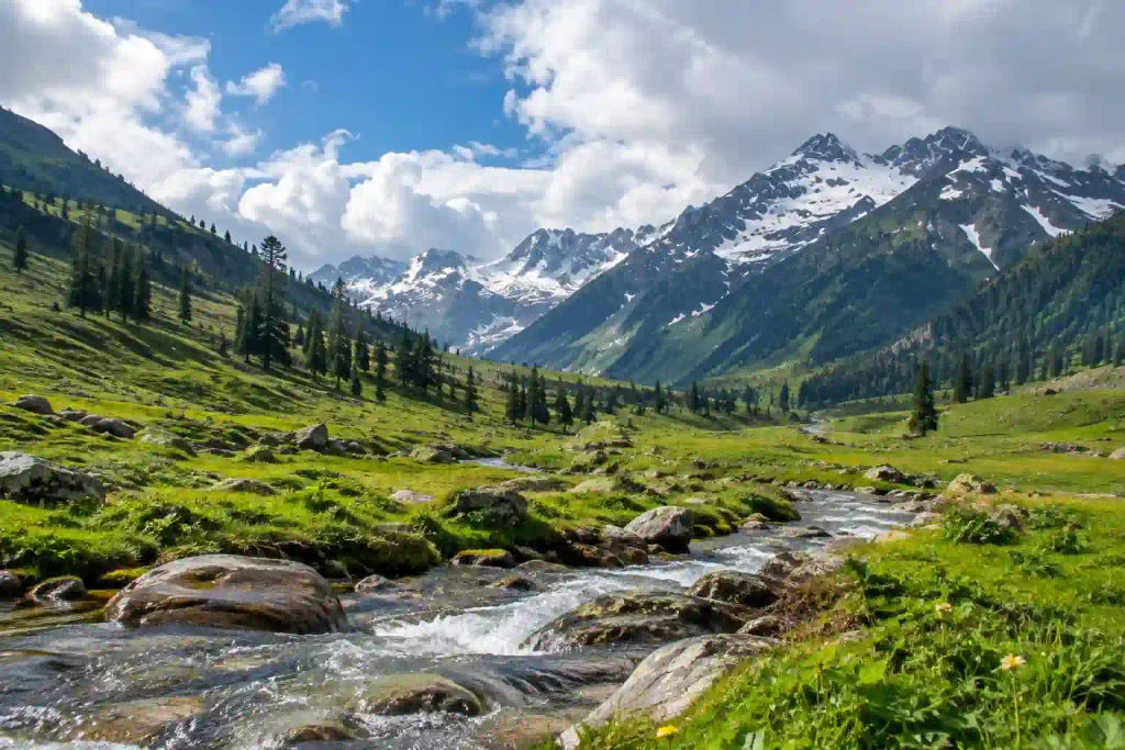 Best Places to Visit in Kashmir 5 Photorealistic landscape of the Thajiwas area in Sonmarg, Kashmir, with a clear mountain stream flowing through a green alpine valley beneath snow-dusted Himalayan peaks and scattered conifer trees.