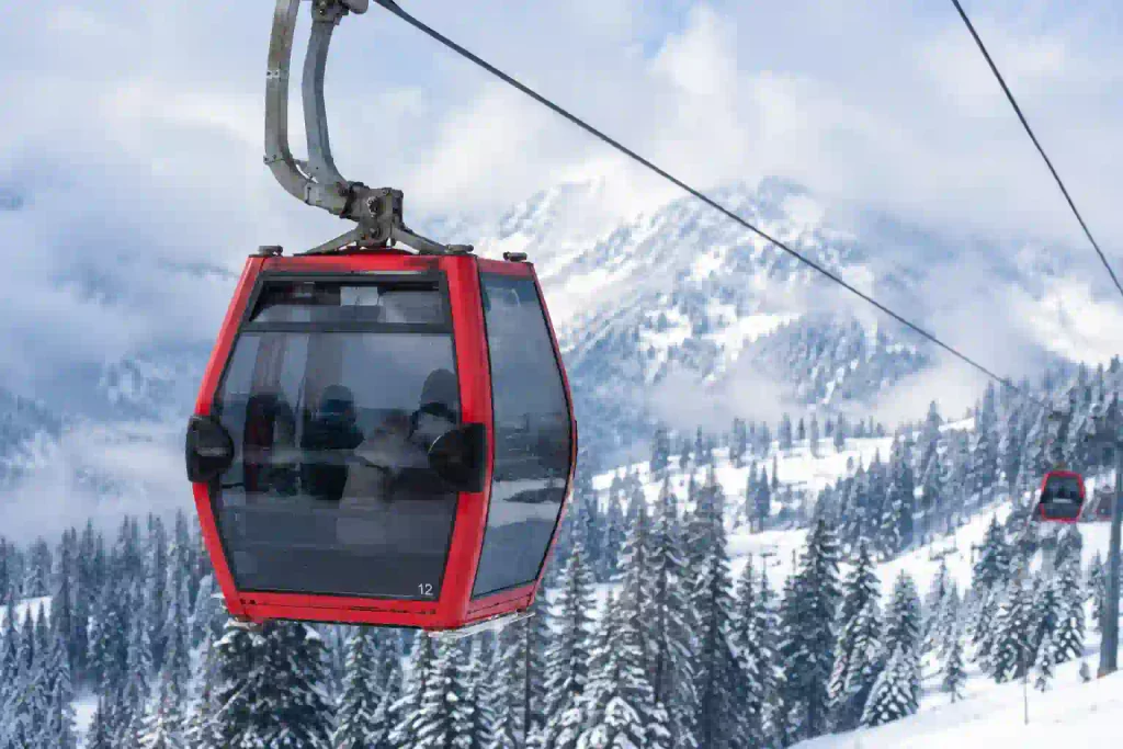 Kashmir in February 2027: A Complete Winter Travel Guide 3 Close shot of a red gondola ride in February with snowy mountains and winter scenery in Kashmir