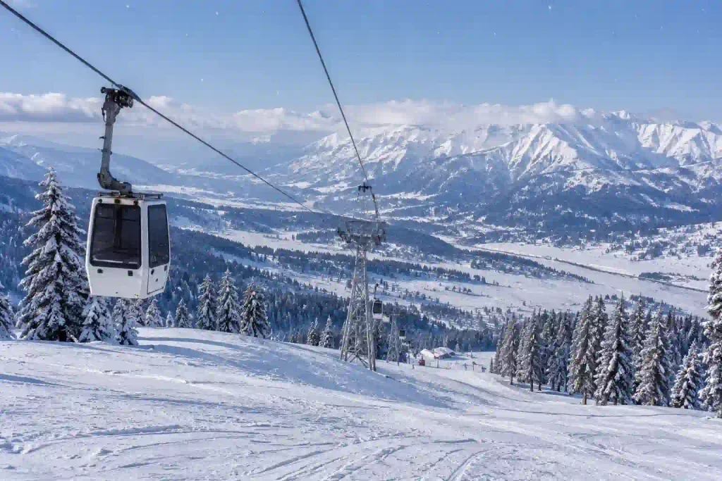Snowy Gulmarg gondola scene showing the Phase 1 and Phase 2 mountain landscape in Kashmir.