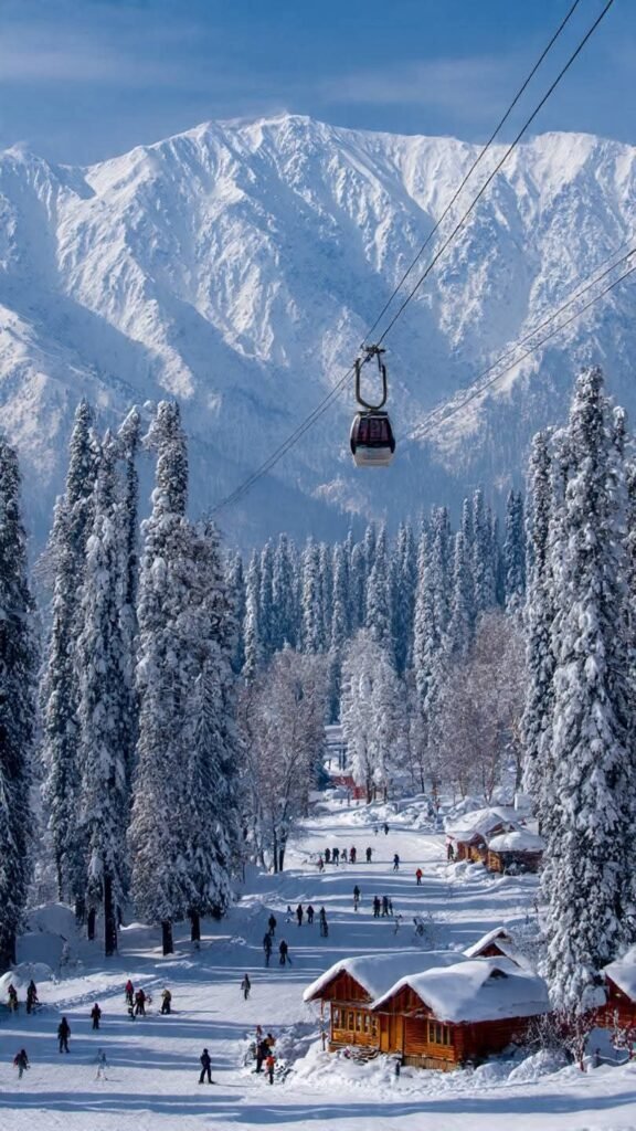 Gulmarg Gondola surrounded by snow-covered mountains and pine trees in winter Kashmir.